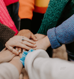 Hands piled on top of each other in act of community